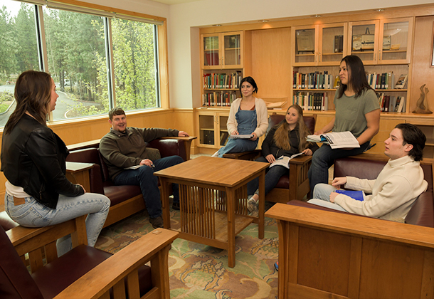 Community College Students Reviewing Financial Aid Options in Library