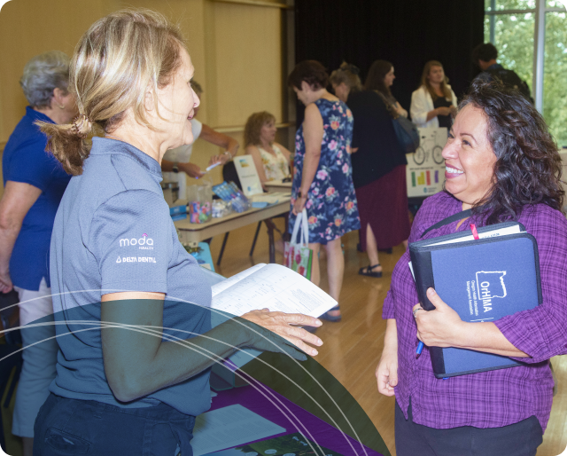 Benefits provider discussing health insurance with employee at COCC benefits fair