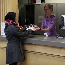 Student checking out course reserves at the Circulation Desk