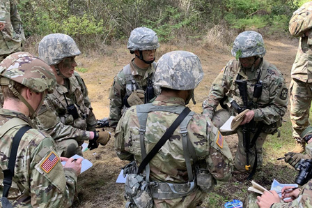 ROTC students in full camo seated in a circle