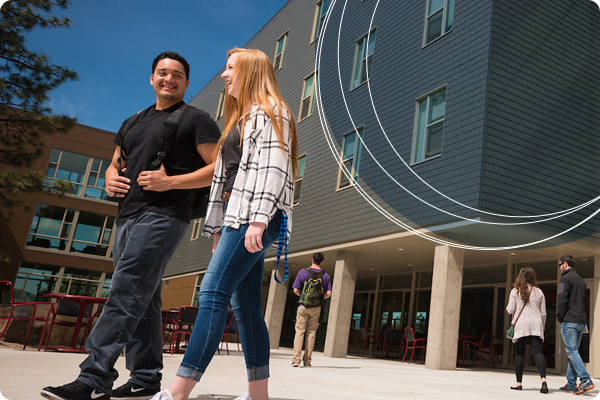 Two students enjoying the warm weather during summer housing