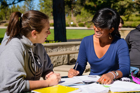 Philosophy students studying on library patio