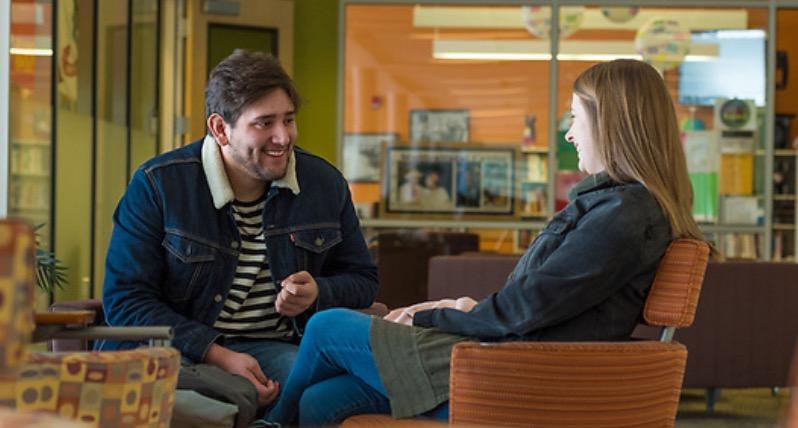 Smiling Man and Woman Discussing COCC's Peer Support Training
