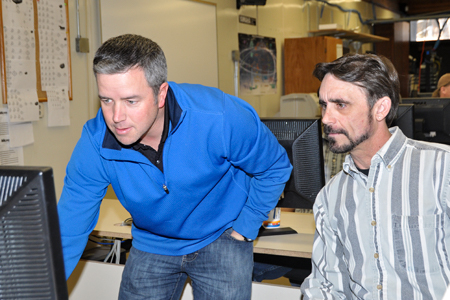 CIS Faculty members working together at desktop computer