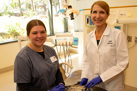 Dental assisiting faculty teaching community college student about dental assisting careers