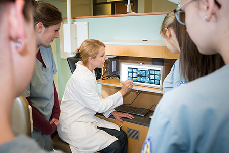 Dental Assisting faculty showing students xray results