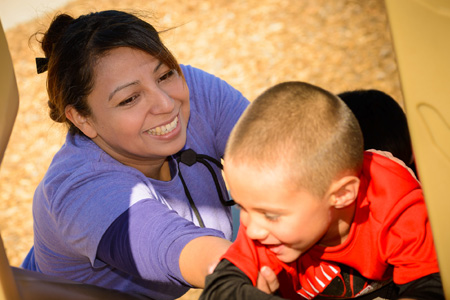 Community College Education Student Helping Child on Playground