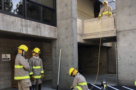 COCC Fire Science students working outside concrete structure