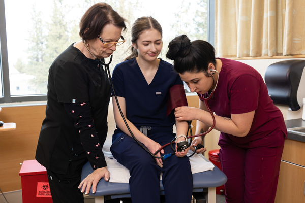 Medical assistant student taking blood pressure readings at a practicum site