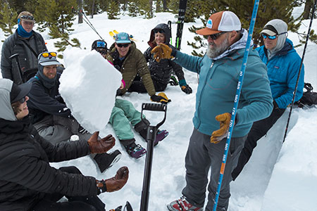 Tim Peterson Tossing Snow Slab to Student