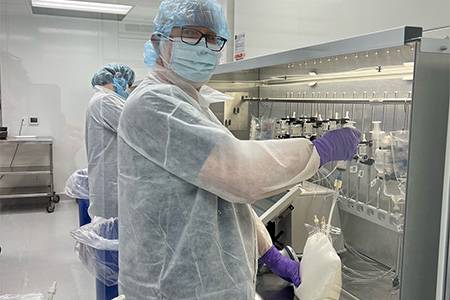 A pharmacy tech student in full lab gear.