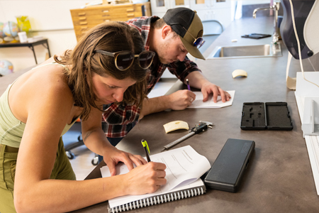 A female and male student performing psychology research at COCC