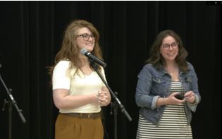 Two presenters talking to the audience 